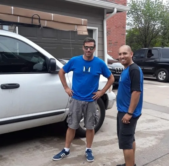 Two men smiling